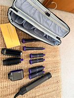 All components laid out: main wand, attachments, case interior