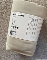 Front of sealed Ikea Ginstmott curtain package showing model name and illustration
