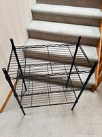 Front view of both three-tier black metal wire racks