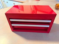 Front view of red mini toolbox with two drawers closed