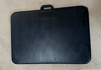 Closed black carrying case with handle