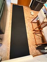 Black rubber underlay mat laid out full length
