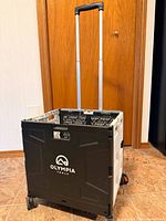 Front view of Olympia Tools collapsible rolling crate showing wheels and extended handle