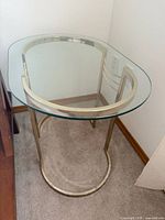 Full view of table showing glass top and brass base