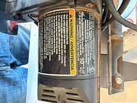 Motor housing label showing specifications and warnings