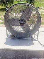 Front view showing full fan, blades, grille, wheeled frame