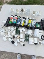 Overhead view of all rotor cartridges, PVC fittings and rubber couplers spread on table