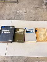 Four repair publications laid out on white surface
