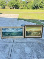 Both framed seascape paintings side by side showing sizes and frames