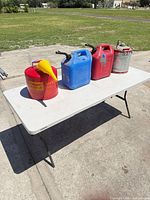 Group shot of four fuel cans on table