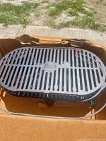Top view of Lodge slotted cooking grate inside box