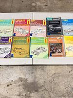 Group shot of 11 manuals laid out on table