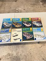 8 Haynes manuals laid out on table