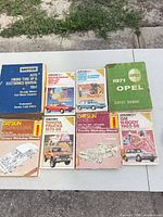 All nine manuals laid out showing covers