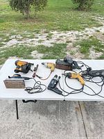 Overall lot showing all power tools on table