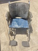 Full frontal view of wheelchair showing seat, backrest, footrests