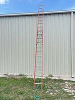 Full view of ladder fully extended against building
