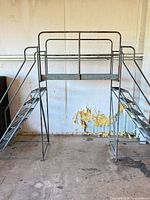 Front view of entire steel work platform with dual staircases and guard rails