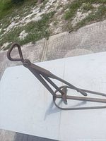 Full view of iron tire bead breaker in folded position on table