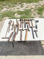 All twelve tools laid out on table outdoors