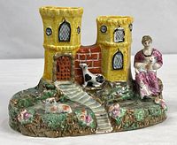 Full view of spill vase showing castle towers, woman, cow, dog and base