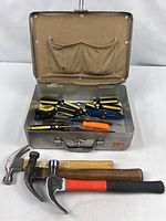 Box open showing interior tools including screwdrivers, pliers, cutters; hammers placed in front