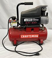 Full left-side view showing tank, motor, label, power cord