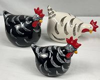 Group shot of three ceramic chickens showing colors and design