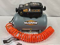 Full view of McGraw 3-gallon compressor with hose and manual