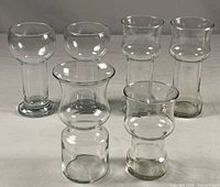 All six clear glass vessels grouped