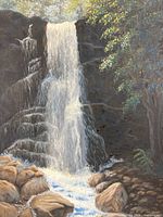 Close view of painted waterfall, rocks, and foliage