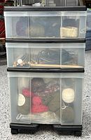 Front view of three-drawer chest showing yarn and needles inside