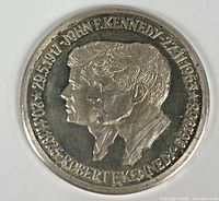 Obverse showing overlapping portraits of John F. and Robert F. Kennedy with rim dates
