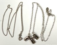 Two sterling silver chains, one with charms
