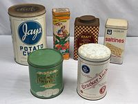 All six vintage advertising tins grouped
