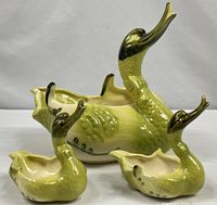 front view of all three ceramic swans showing size relation and glaze