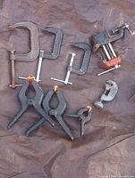 All clamps laid out on tarp showing type and condition