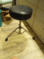 Full view of drum throne showing seat pattern and chrome base