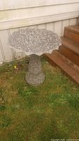 Full view of concrete bird bath with exposed aggregate finish on lawn beside steps
