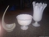 Three decorative pieces: hobnail vase, pedestal compote bowl, curved ceramic basket