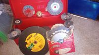 Overall view of red toolbox section showing DeWalt disc, wire wheels, saw blades in Simonds sleeve and other discs