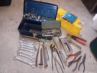 Overview of hand tool lot with toolbox, organizer, wrenches, pliers, staple gun, files, punches