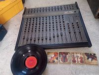 Overall view of mixer, vinyl record and four coasters