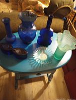 All seven glass pieces on small table