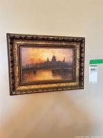 Framed oil painting hung on wall