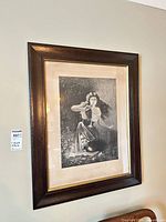 Framed photogravure on wall