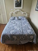 full view of made bed showing headboard design and bedding