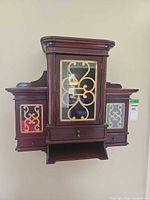 Front view showing full cabinet with glass door, side panels, drawer and shelf