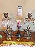 Group view showing pair of brass cherub candleholders and single silverplate painted glass candleholder with height labels