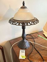 Full view of lamp showing glass shade, metal base, cord, height reference